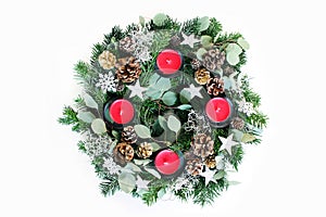 Christmas advent wreath isolated on white table background. Decorated by evergreen fir tree branches, eucalyptus leaves