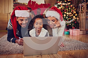 Christmas afro African young cheerful family using laptop