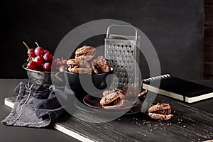 Christmas almond cookies on dark wooden background