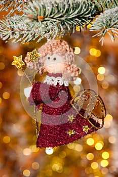 Christmas angel on fir tree branch