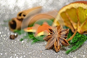 Christmas anise, cinnamon, dry orange round and star shape slice with badian, clove spices, green pine and spruce branch