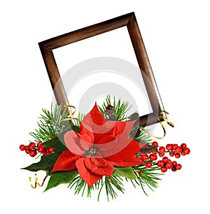 Christmas arrangement with red poinsettia flower , berries, cones, golden ribbons and a wooden frame isolated on white
