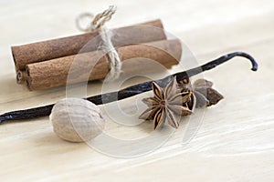 Christmas arrangements on wooden table, Xmas spice collection, cinnamon, nutmeg, vanilla pod and anise spice