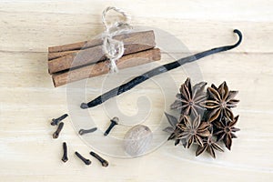 Christmas arrangements on wooden table, Xmas spice collection, cinnamon, nutmeg, vanilla pod and anise star