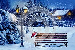 Christmas art card. Santa hat on a bench in the snow against the background of the Christmas winter forest. Village house in the b