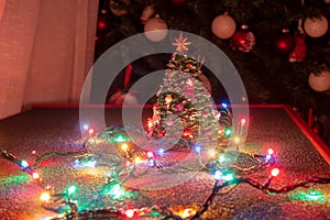 Christmas atmosphere recreated through the typical Christmas lights, with the decorated Christmas tree.