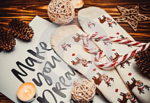 Christmas decorations and socks on wooden brown background with candle