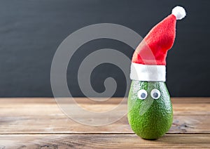 Christmas avocado. avocado in christmas hat. holidays concept