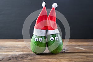 Christmas avocado couple. avocado in christmas hat