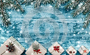 Christmas azure background with handmade gifts and fir branches at the top of the picture. Space for text