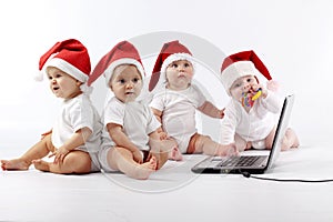 Christmas babies with laptop