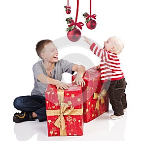 Christmas baby boy with gift box with brother