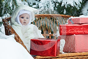 Christmas baby with gift on vinewoven bench