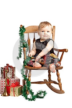 Christmas baby with gifts rocks in patchwork dress