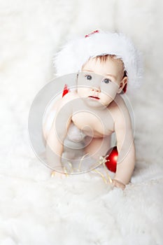 Christmas baby in red hat on fur