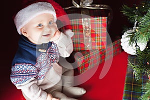 Christmas baby sitting near christmas tree and gift box!