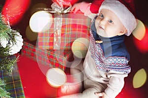 Christmas baby sitting near christmas tree and gift box!