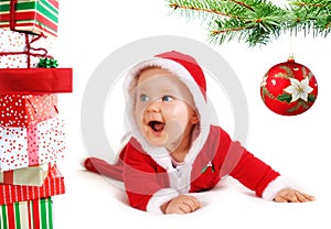 Christmas baby unders a tree with gifts