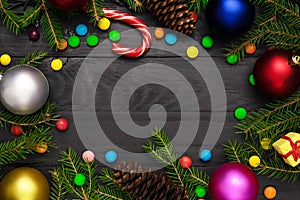 Christmas back,ground, green fir branches, red and blue , golden balls, candies, cone, gift box, black boards