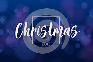 Christmas background 2019 with blue magic bokeh sparkle glitter lights. Abstract defocused circular New Year background