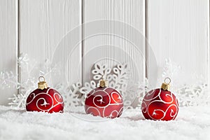 Christmas background - baubles and snowflakes on snow