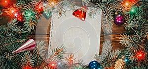 Christmas background with blank notebook for to-do list or wish list. with Christmas fir branches
