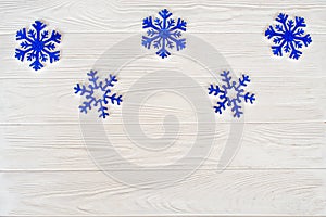 Christmas background.Blue snowflakes on a white wooden background.Top view.New Year holidays concept.