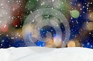 Christmas background with blue, yellow and white bokeh lights and falling snow