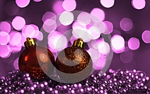 Christmas background, with blurred Christmas lights, beautiful bokeh and a chain of glossy balls in the foreground. Christmas