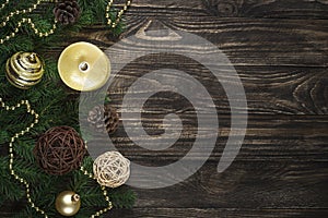Christmas background with candle and decorations on dark wooden table.