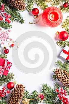 Christmas background with candle and decorations on white.