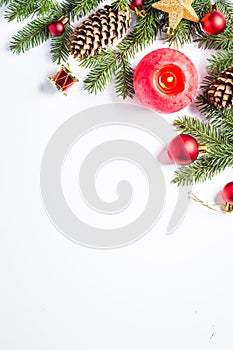 Christmas background with candle and decorations on white.