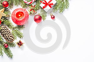 Christmas background with candle and decorations on white.