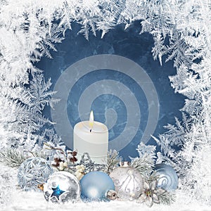 Christmas background with candles, pine branches, balls on a blue background with a frosty pattern