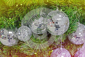 Christmas background celebrate decorated pine Christmas tree with mirror sparkle ball above green leaf background