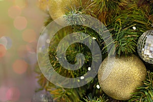 Christmas background celebrate decorated Christmas tree with golden sparkle ball above green leaf background