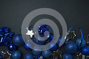 Christmas background Christmas blue deco bubblers on a dark black background. Christmas blue decoration. New Year card. Space for