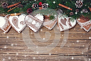 Christmas background. Christmas fir tree branch with decoration, gingerbread cookies. Copy space