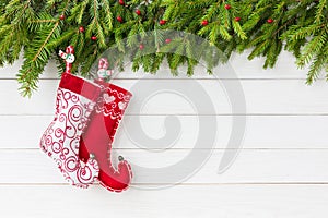 Christmas background. Christmas fir tree with Christmas socks on white wooden board background, copy space.