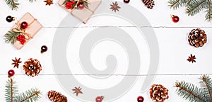 Christmas background with Christmas gift, fir branches, pine cones, snowflakes, red decorations.