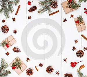 Christmas background with Christmas gift, fir branches, pine cones, snowflakes, red decorations.