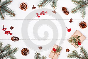 Christmas background with Christmas gift, fir branches, pine cones, snowflakes, red decorations. Flat lay, top view