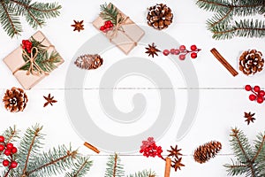 Christmas background with Christmas gift, fir branches, pine cones, snowflakes, red decorations. Flat lay, top view