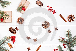 Christmas background with Christmas gift, fir branches, pine cones, snowflakes, red decorations. Xmas and Happy New Year