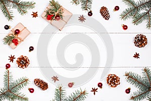 Christmas background with Christmas gift, fir branches, pine cones, snowflakes, red decorations. Xmas and Happy New Year