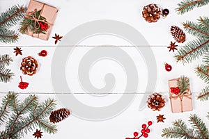 Christmas background with Christmas gift, fir branches, pine cones, snowflakes, red decorations. Xmas and Happy New Year