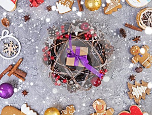 Christmas background. Christmas gift, toys, gingerbread cookies, spices and decorations on wooden background. Top view