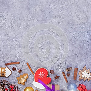 Christmas background. Christmas gift, toys, gingerbread cookies, spices and decorations on wooden background. Top view