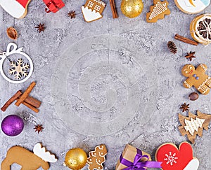 Christmas background. Christmas gift, toys, gingerbread cookies, spices and decorations on wooden background. Top view