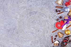 Christmas background. Christmas gift, toys, gingerbread cookies, spices and decorations on wooden background. Top view